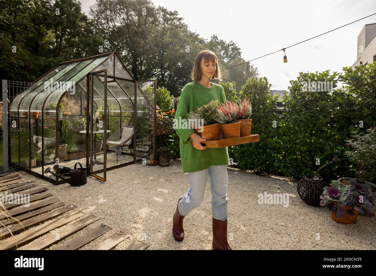 Woman with plants at backyard Stock Photo - Alamy