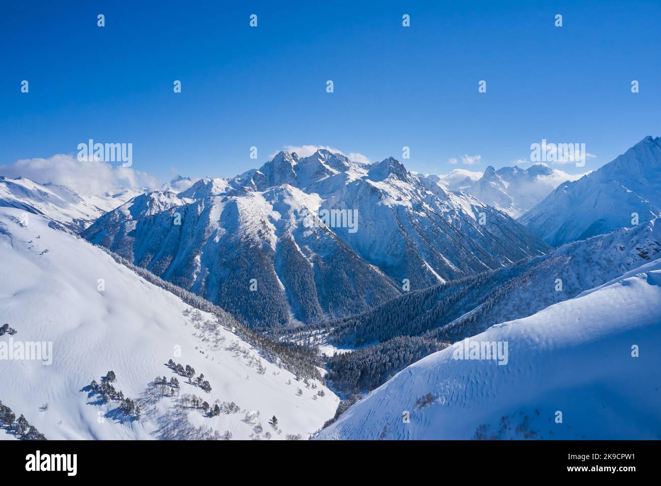 View of the snow capped mountain and snow-covered gorge. Stock Photo