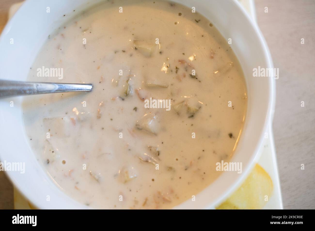 Clam chowder closeup in a white bowl with a spoon. USA Stock Photo