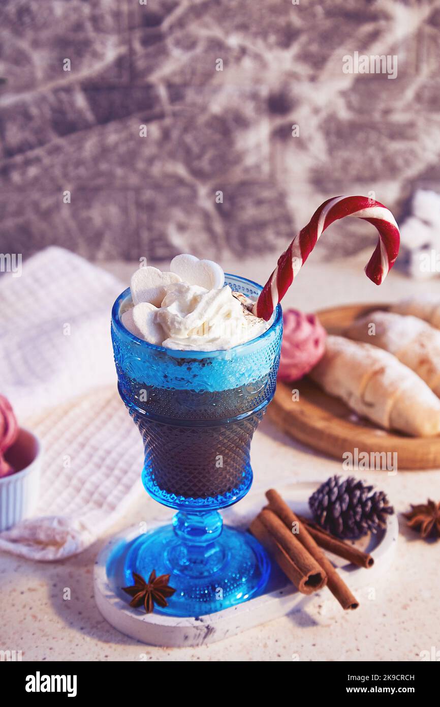 Viennese coffee with caramel stick with spices, cinnamon sticks. Christmas pastry handmade crescent bagels and marshmallow. Stock Photo