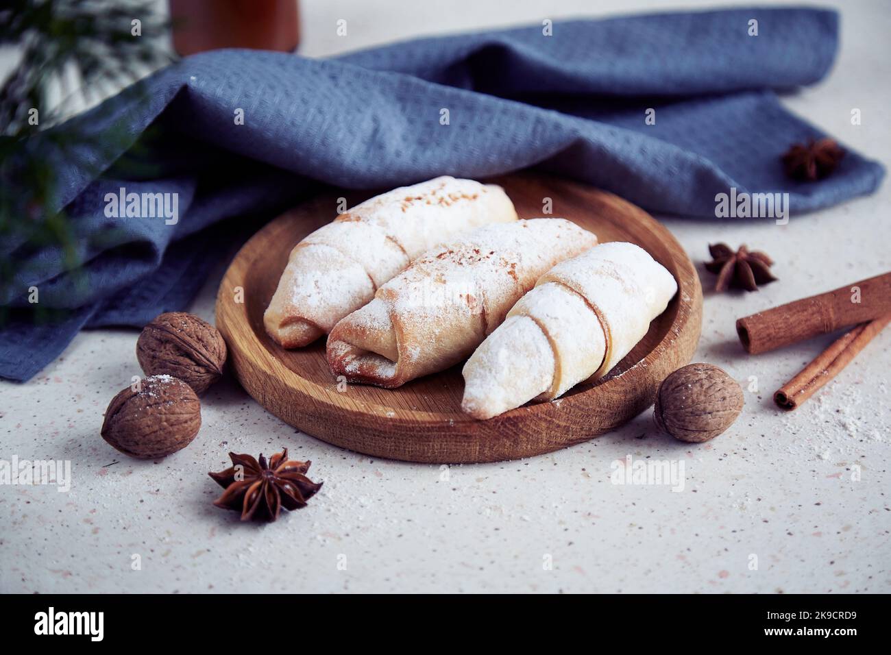 Traditional aesthetics Christmas crescent bagels with cinnamon sticks, star anise, walnuts. Stock Photo