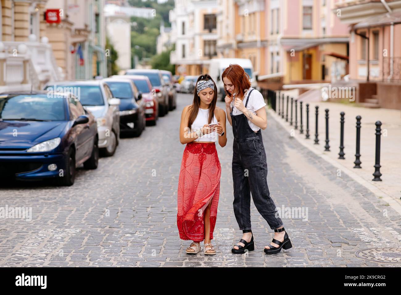 two young women walking outdoor having fun Stock Photo - Alamy