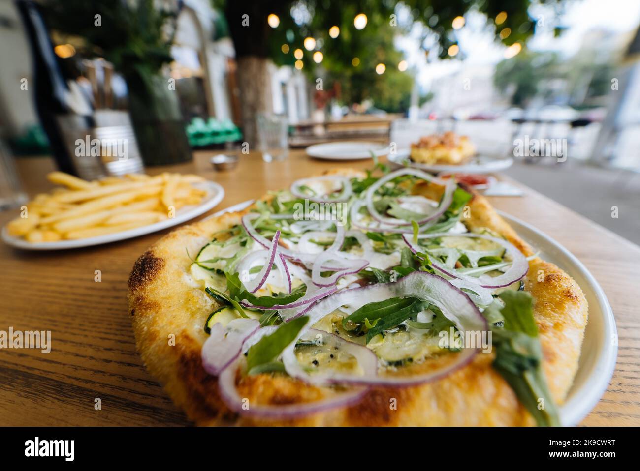 Vegetarian pizza in street fast food outdoor cafe. Stock Photo