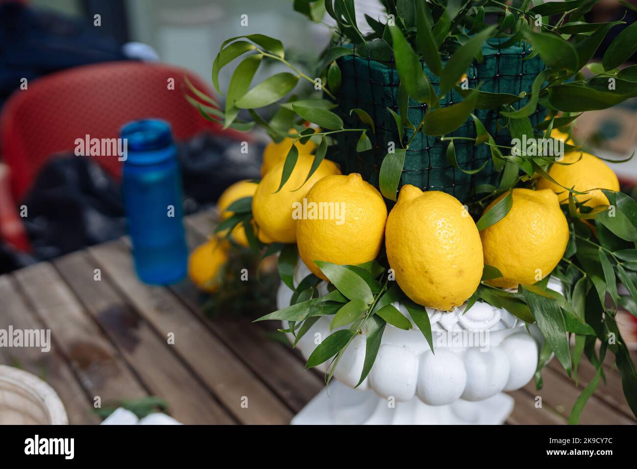 Wedding composition with green leaves and lemons, close view Stock Photo