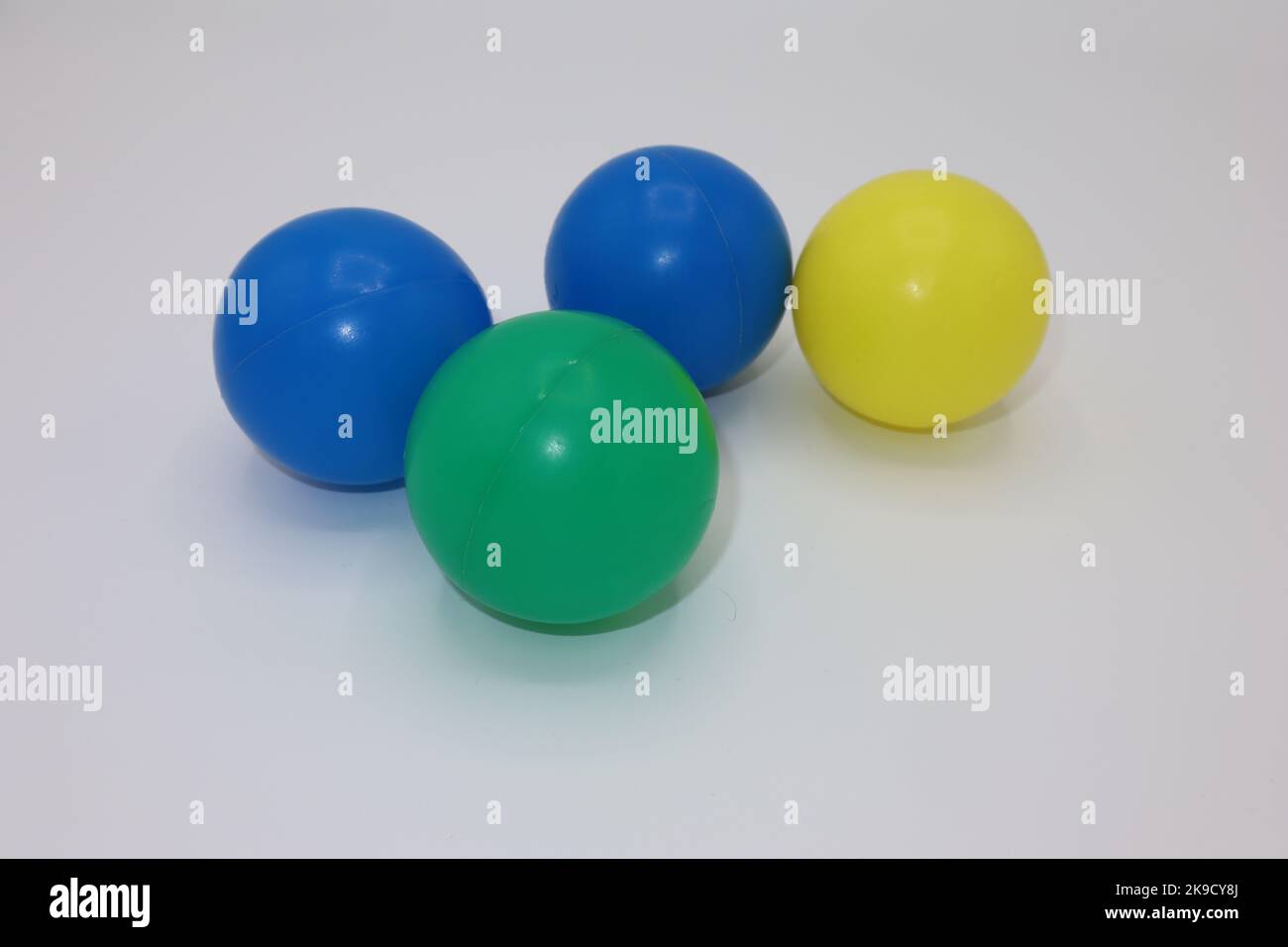 Colorful plastic balls on a white background Stock Photo - Alamy