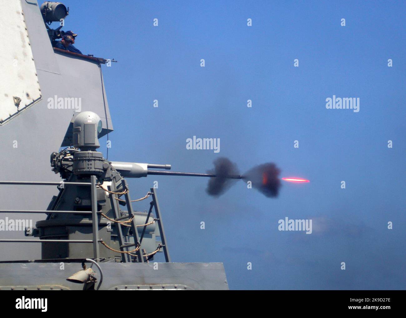 An MK-38 25mm gun system is fired during a live-fire exercise aboard the guided-missile destroyer USS Mason (DDG 87). U.S. Navy. The Mark 38 25 mm Machine Gun System (MGS) is a shipboard weapon system designed to protect warships primarily from a variety of surface threats, especially small, fast surface craft. It consists of an M242 Bushmaster chain gun mounted on a turret that can be either manually or remote controlled, depending on variant. Stock Photo