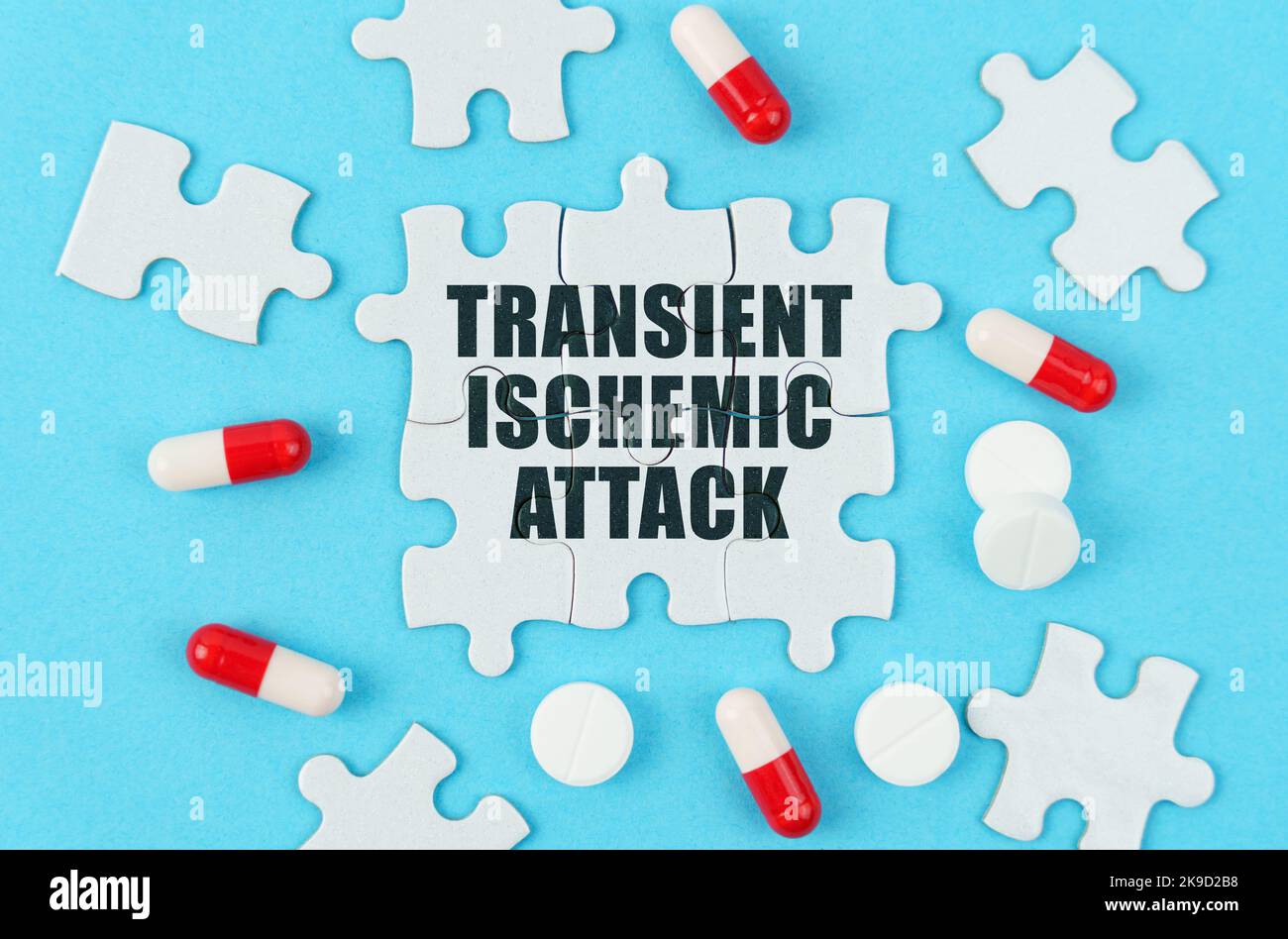 Medical concept. On a blue background, pills, capsules and puzzles with ...