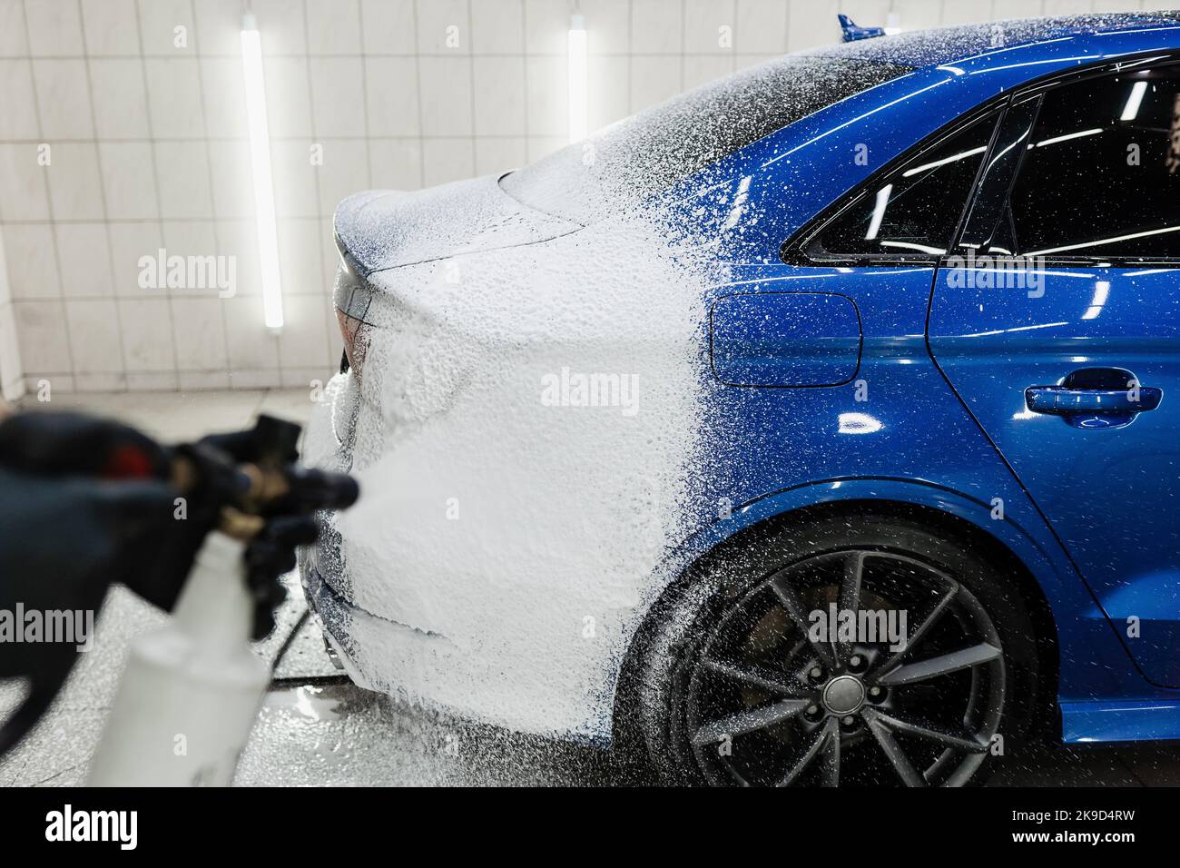 Process of spraying foam on the car body in the garage. Second phase of ...