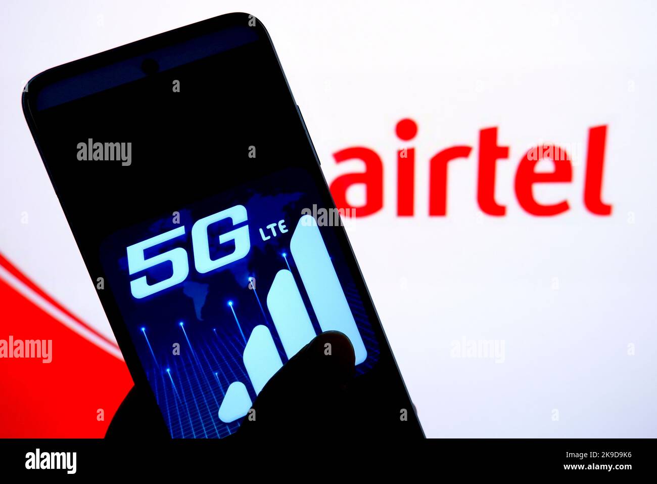 In this photo illustration, a 5G logo is displayed on a smartphone with an Airtel logo in the background. Stock Photo