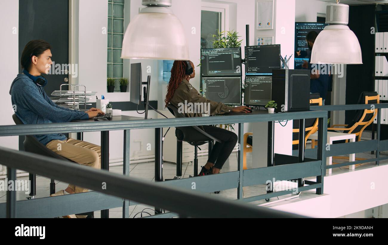 Software developer typing programming code on computer keyboard, innovating online cloud computing. Casual programer sitting at desk developing html script on terminal window server. Stock Photo