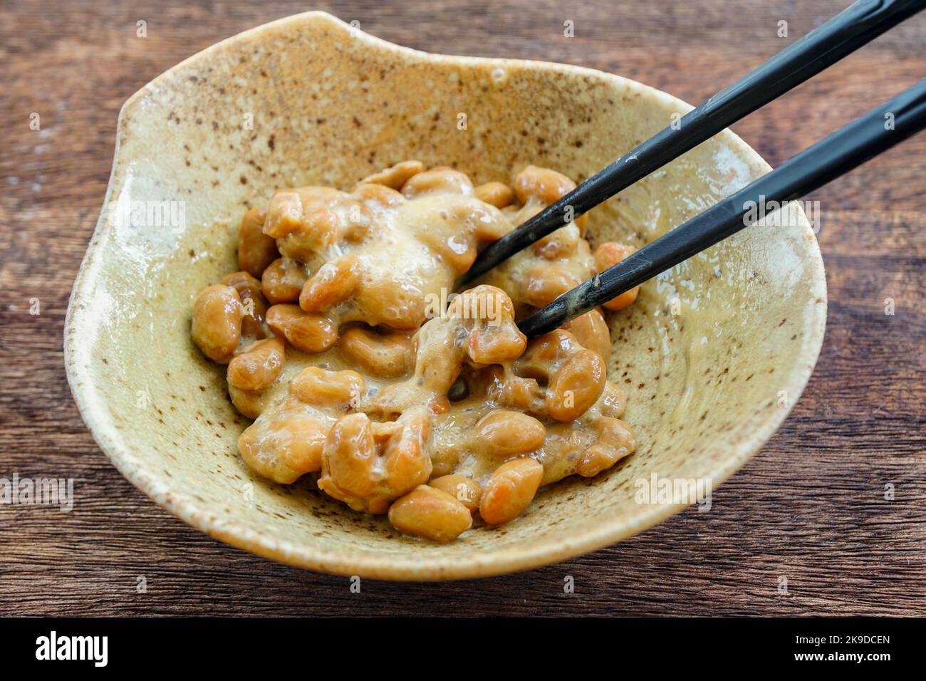 Natto, Japanese fermented soybeans being mixed with chopsticks Stock