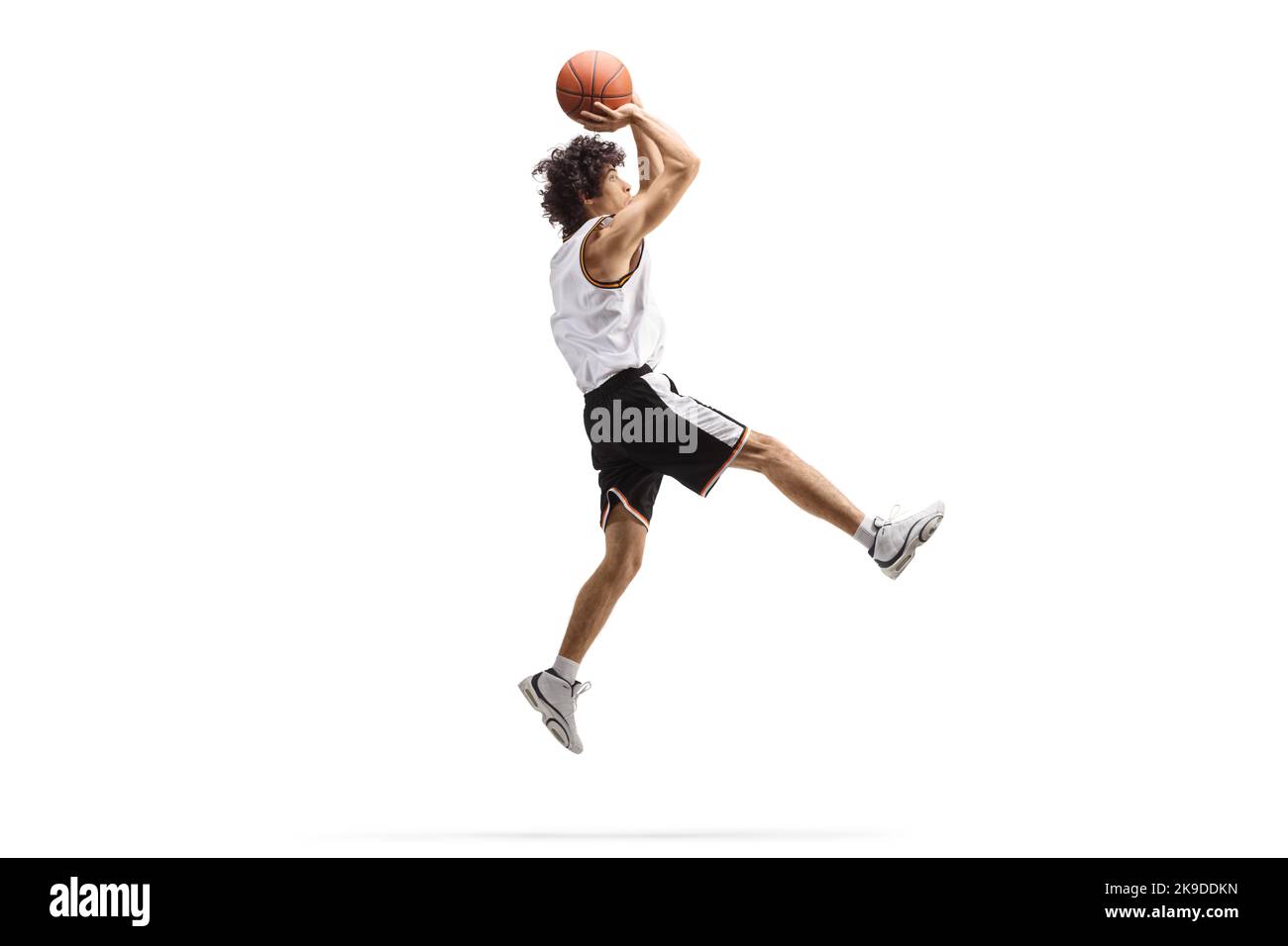 Athlete jumping and shooting a basketball isolated on white background Stock Photo Alamy