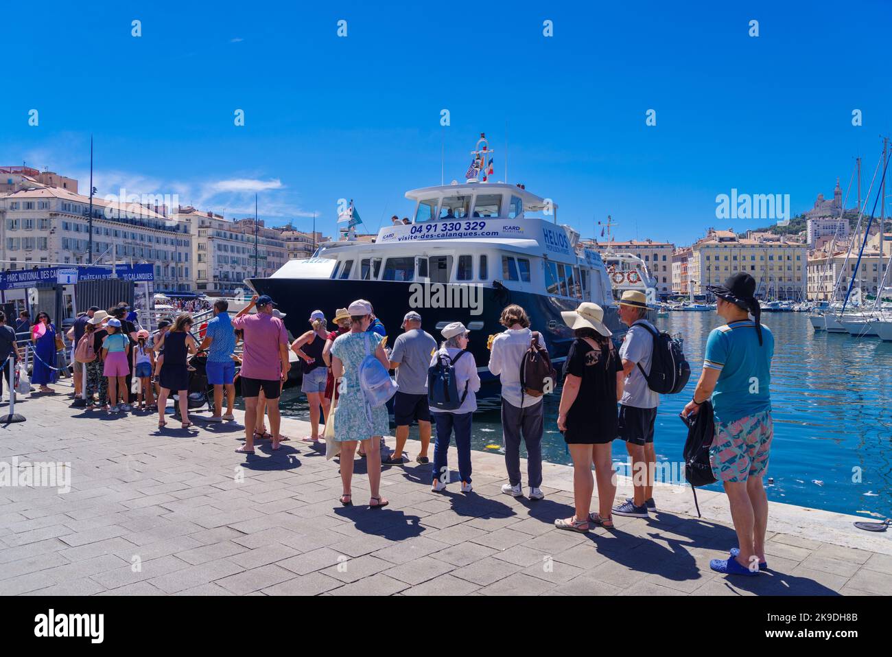 MARSEILLE, FRANCE - AUGUST 2, 2022:  People waiting in a queue for a sightseeing boat.. It has been the natural harbour of the city since antiquity an Stock Photo