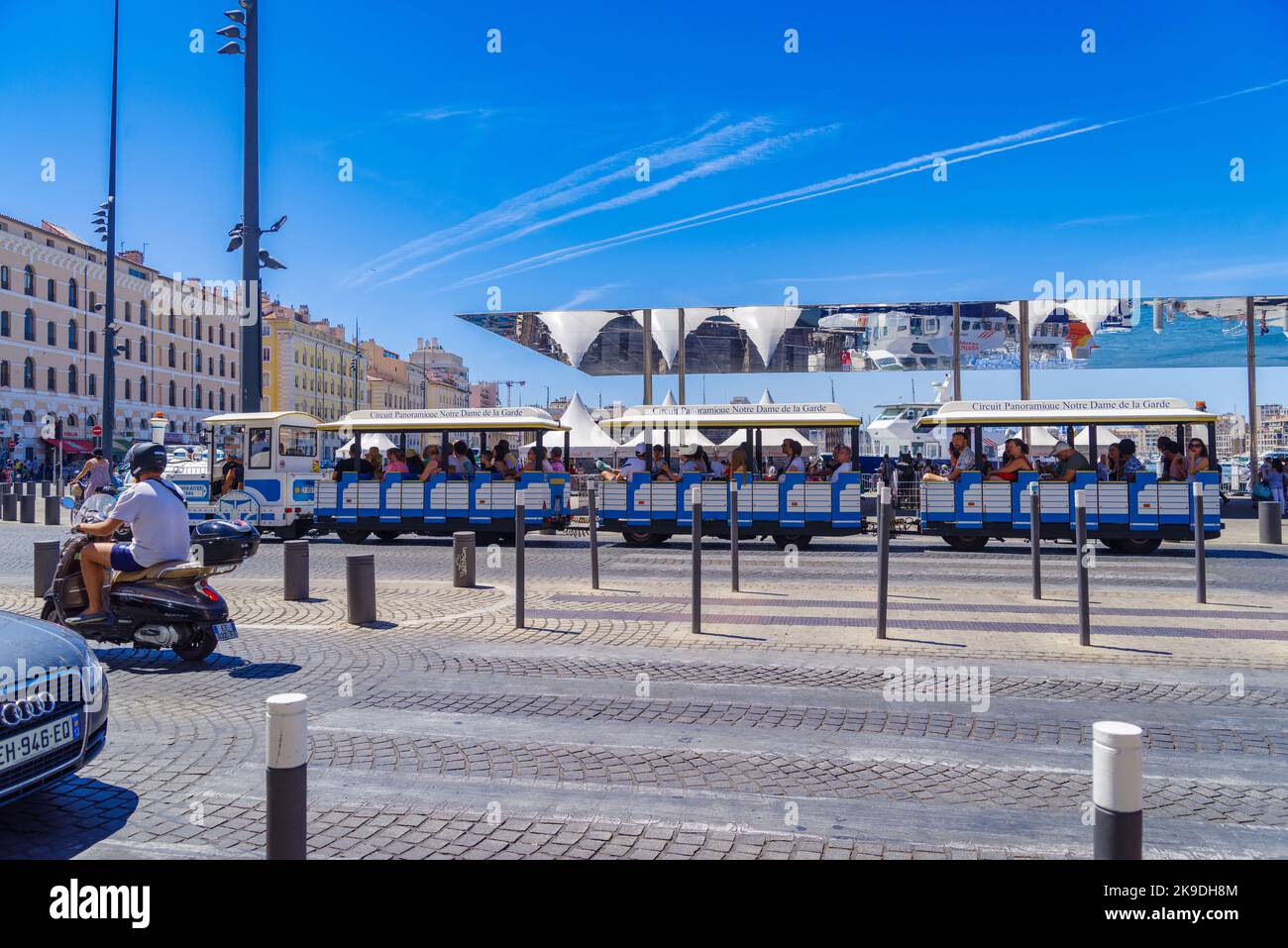 MARSEILLE, FRANCE - AUGUST 2, 2022: Tourists in sightseeing train in the old harbor (vieux port). It has been the natural harbour of the city since an Stock Photo