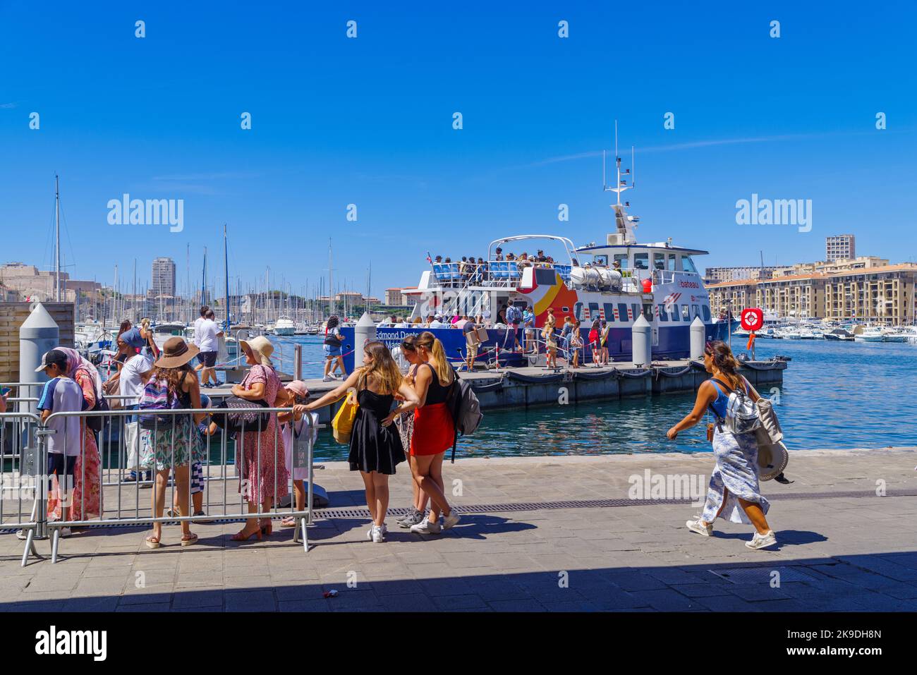MARSEILLE, FRANCE - AUGUST 2, 2022: People waiting in a queue for a sightseeing boat.. It has been the natural harbour of the city since antiquity and Stock Photo
