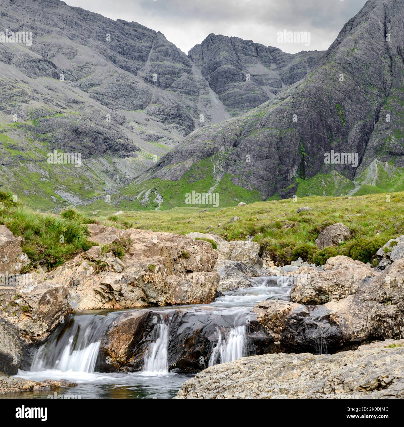 Long line of waterfalls and rocky mountain pools at the foot of the ...