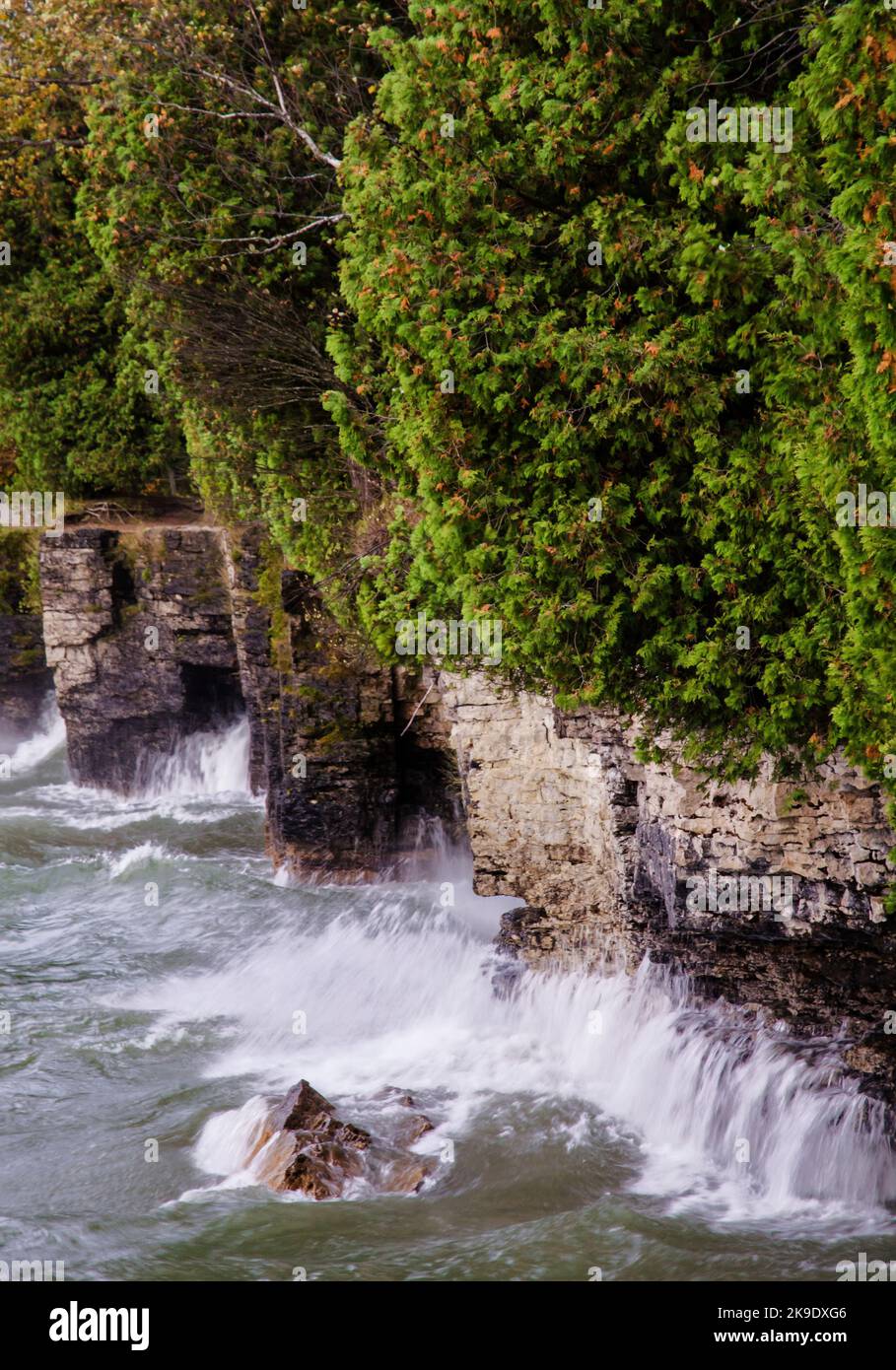 An autumn storm whips up Lake Michigan and its waves pound the Cave Point County Park shoreline limestone clifs, Door County, Wisconsin Stock Photo