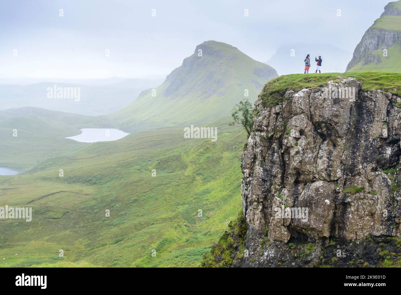 Beautiful,dramatic Scottish, Skye mountain scenery,jagged peaks,winding road and sheer cliffs, along the Quiraing hills walk,green course grass covere Stock Photo