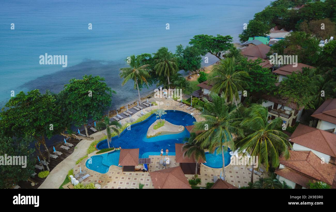 Drone aerial view of a luxury hotel pool from above. A couple of men ...