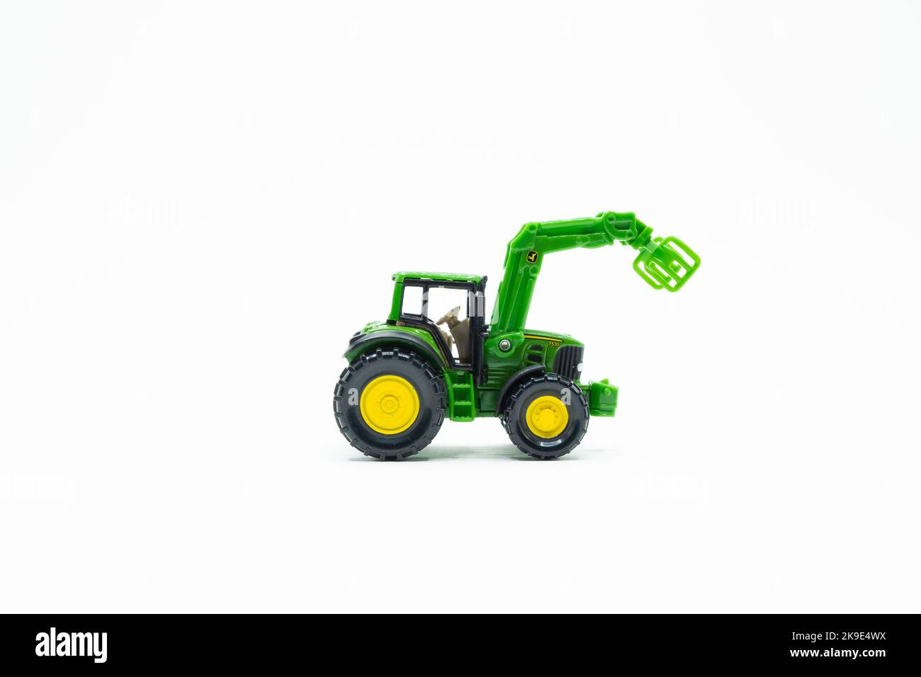 Green and yellow Tractor toy on white background Stock Photo Alamy