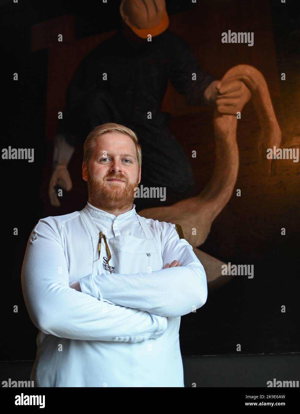 20 October 2022, Hesse, Frankfurt/Main: Ricky Saward, chef at the Seven Swans restaurant in downtown Frankfurt, stands in front of a painting in the dining room. The restaurant has been awarded a Michelin star and serves only vegan cuisine made from regional ingredients. Photo: Arne Dedert/dpa Stock Photo