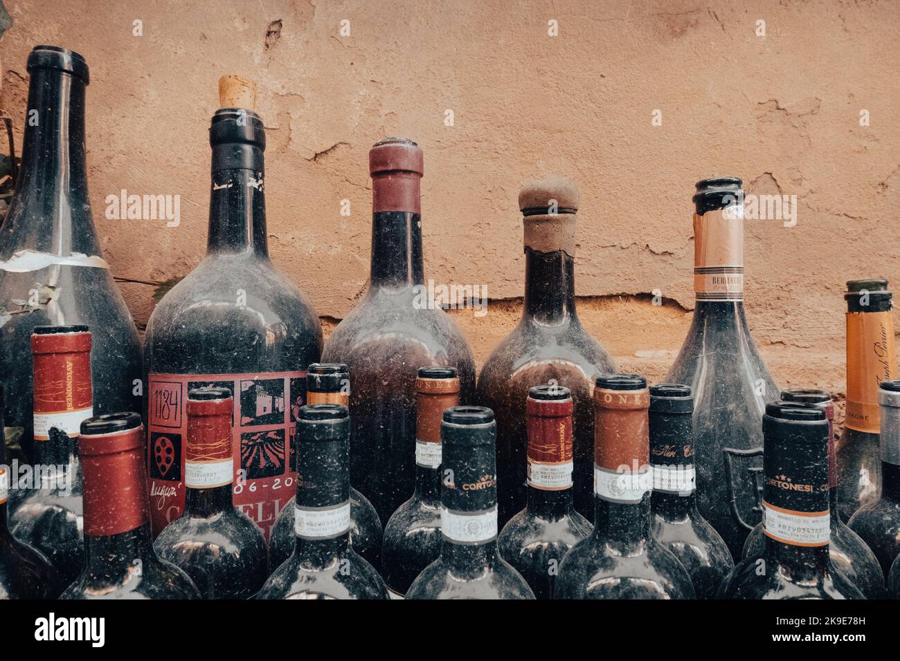 Old open red wine bottles full of dust Stock Photo Alamy
