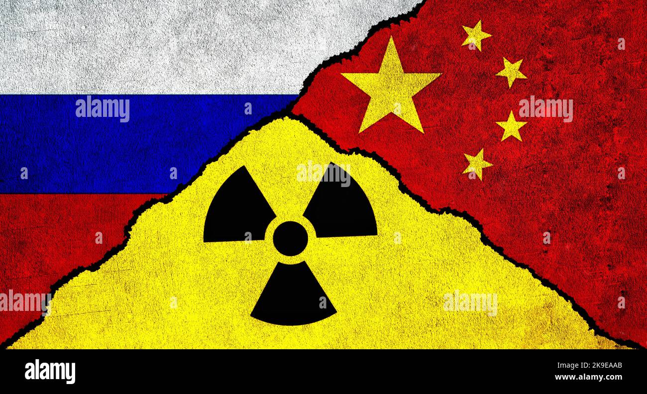 Flags of Russia, China and Nuclear symbol together on textured wall