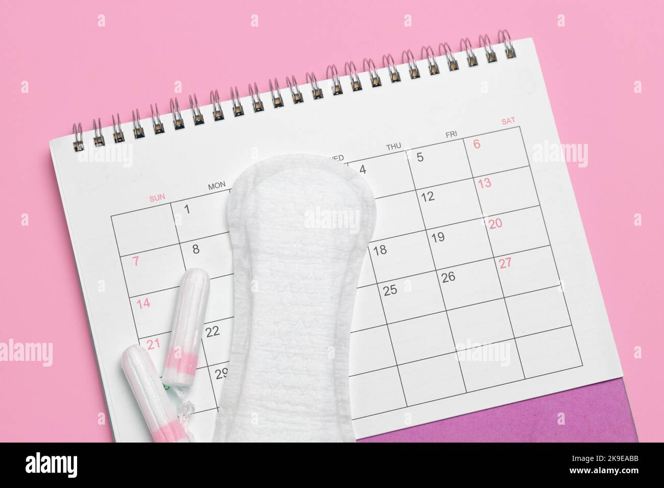 Menstruation calendar. Calendar with pads and tampons on a pink