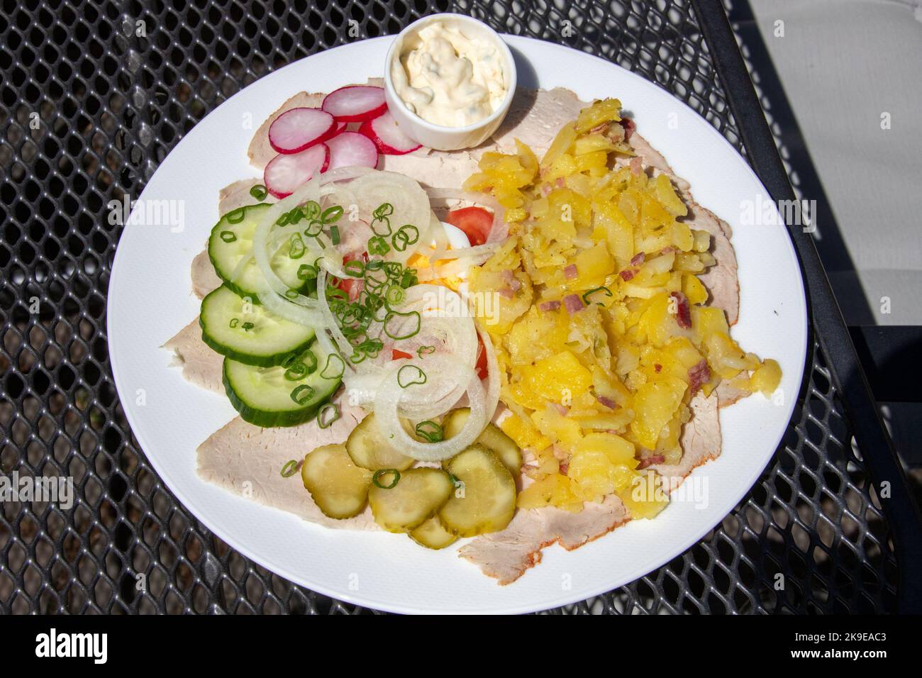 Bratenbrot vom Eifeler Landschwein, potato salad on roast pork at Zum Grunen Baum Restaurant, Bacharach, Germany Stock Photo
