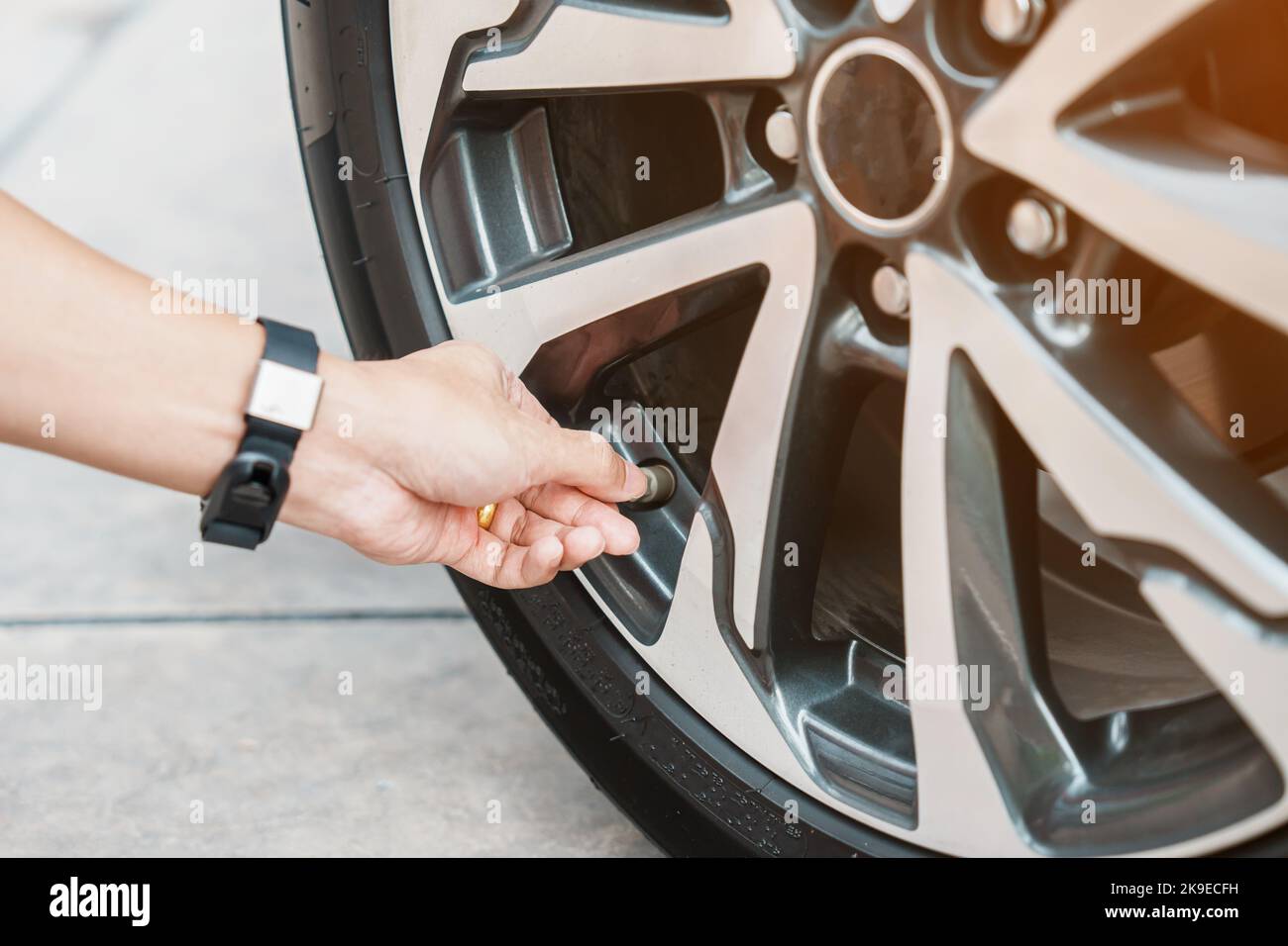driver hand inflating tires of vehicle, removing tire valve nitrogen