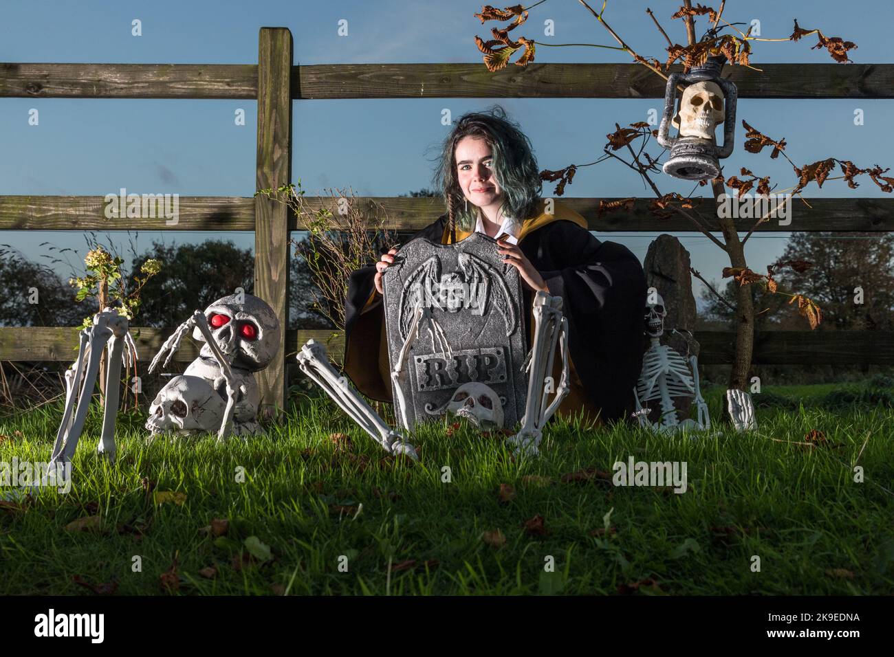 Bartlemy, Cork, Ireland. 27th October, 2022.Shauna Morrissey crouches behind a tombstone as she gets ready for the halloween weekend in Bartlemy, Co. Cork, Ireland. - Credit; David Creedon / Alamy Live News Stock Photo