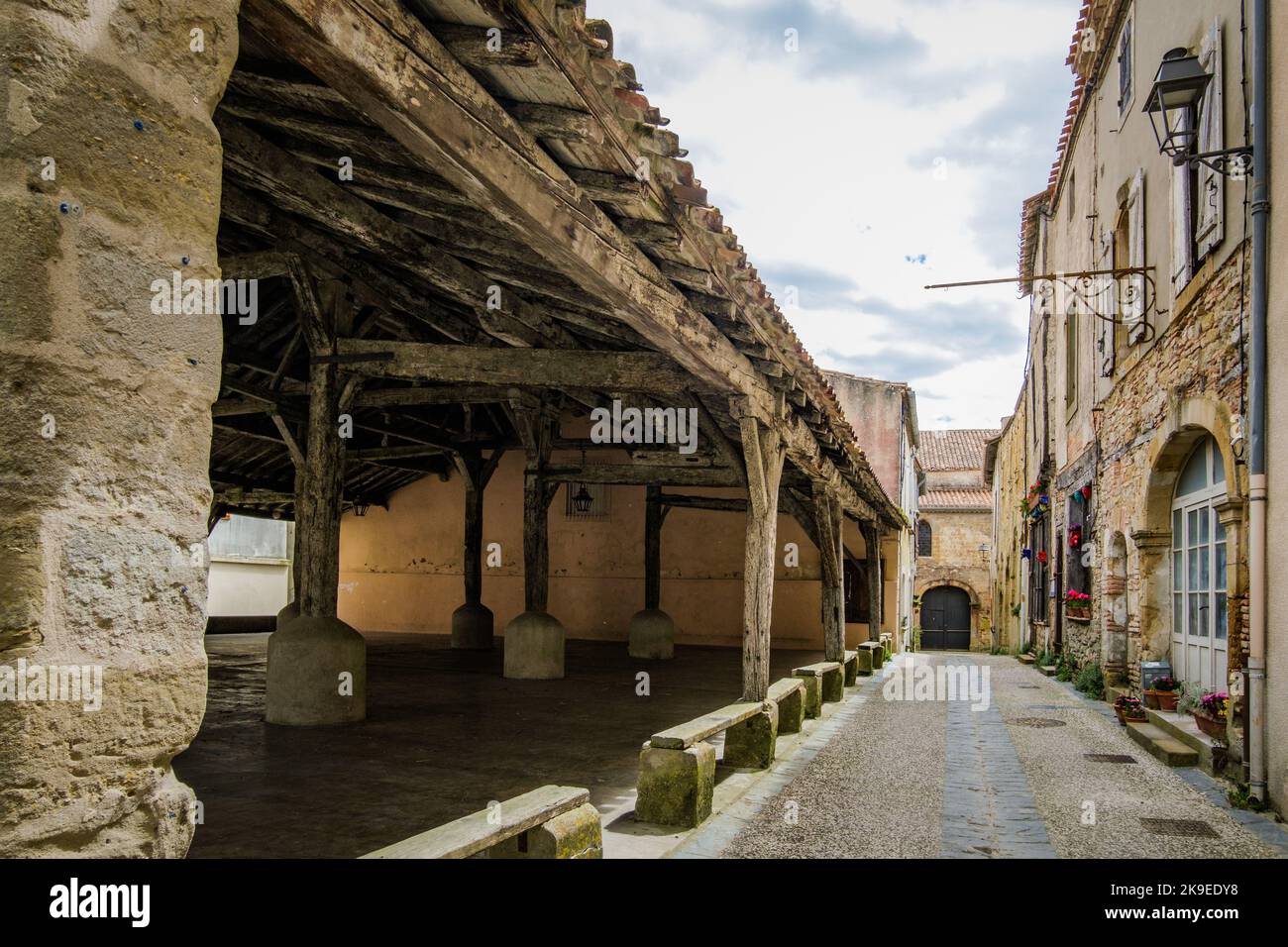 Narrow street, old facade and medieval market hall in the village of Fanjeaux in the south of France (Aude) Stock Photo