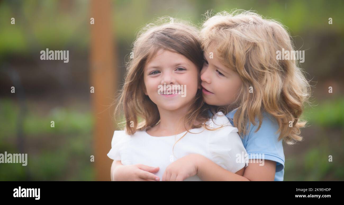 Little Brother And Sister By The Lake Hugging Tight And Beeing Happy  Together In Nature And Outdoors. Girl And A Boy Sitting On A Grass Stock  Photo, Picture and Royalty Free Image.