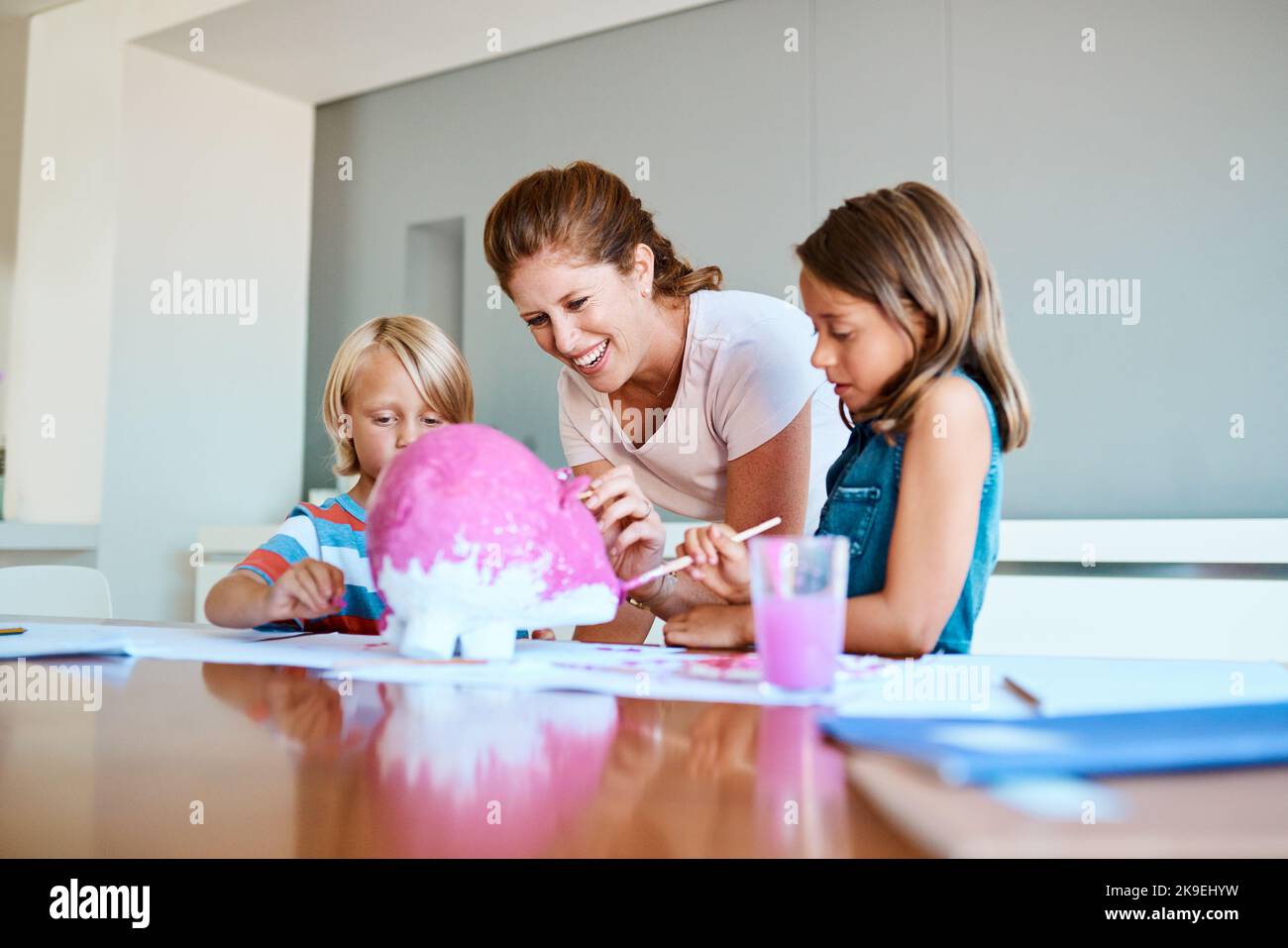 Living a life full of color with my little painters. a young mother helping her two small children with their art project at home. Stock Photo