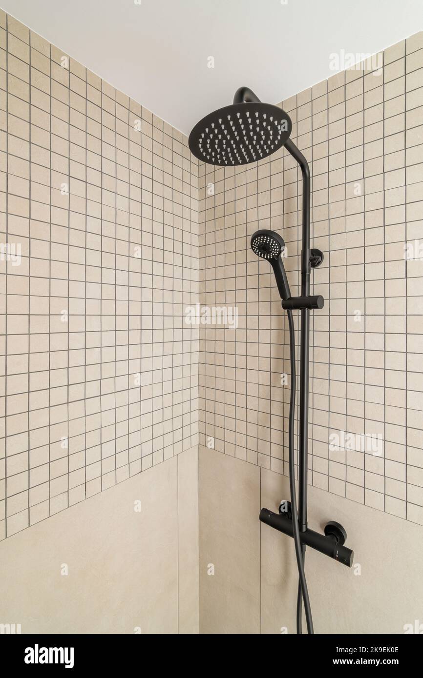 https://c8.alamy.com/comp/2K9EK0E/modern-shower-zone-with-rain-head-hand-held-shower-beige-tiles-in-the-bathroom-2K9EK0E.jpg
