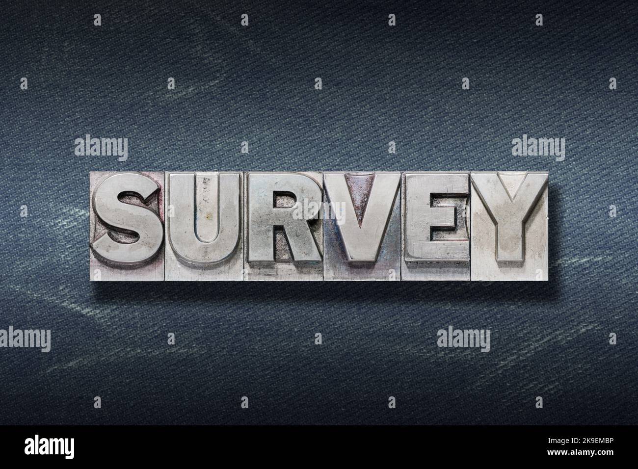 survey word made from metallic letterpress on dark jeans background Stock Photo