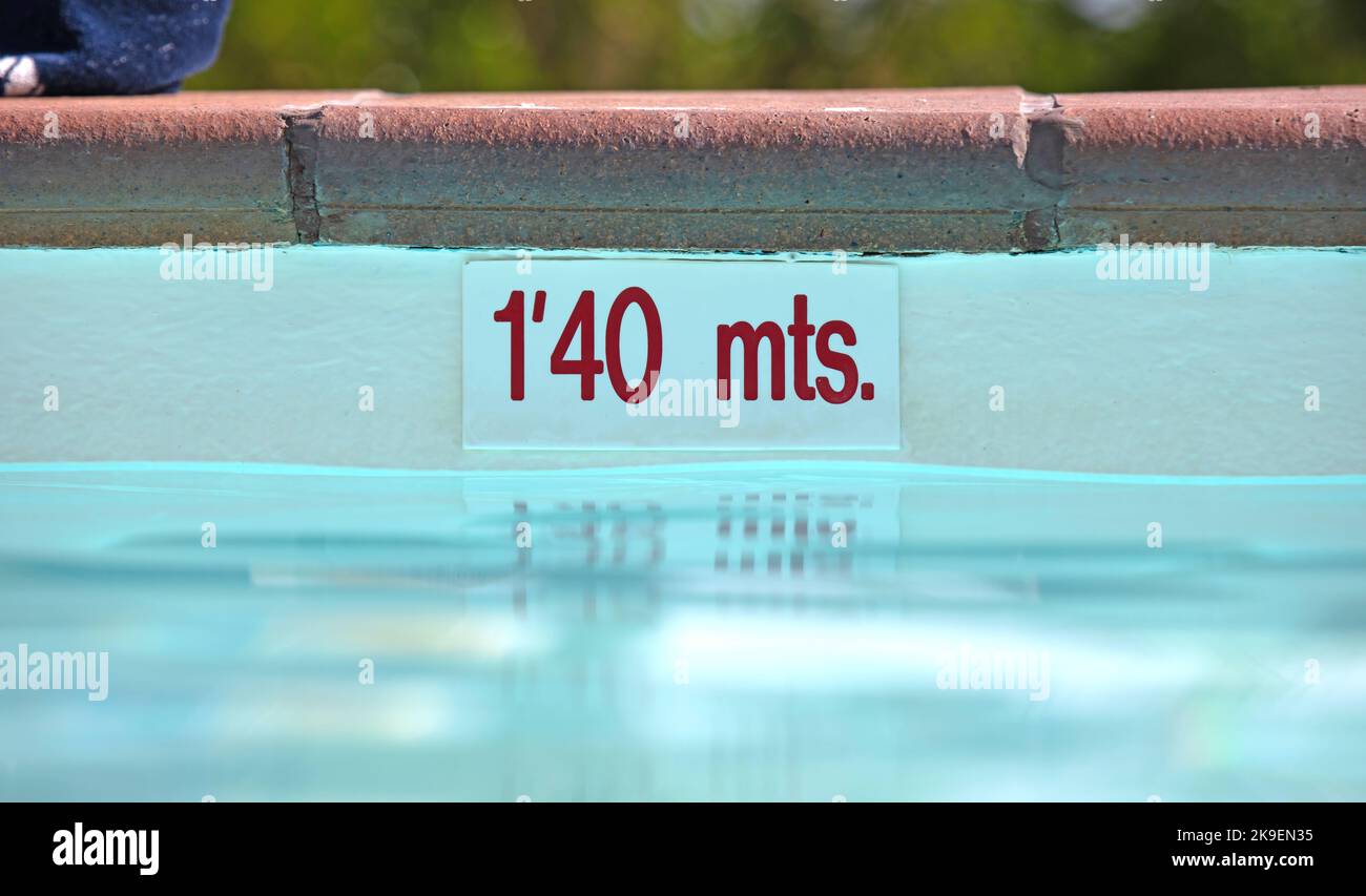 Pool depth sign at the edge of the swimming pool 1'40 mts Stock Photo