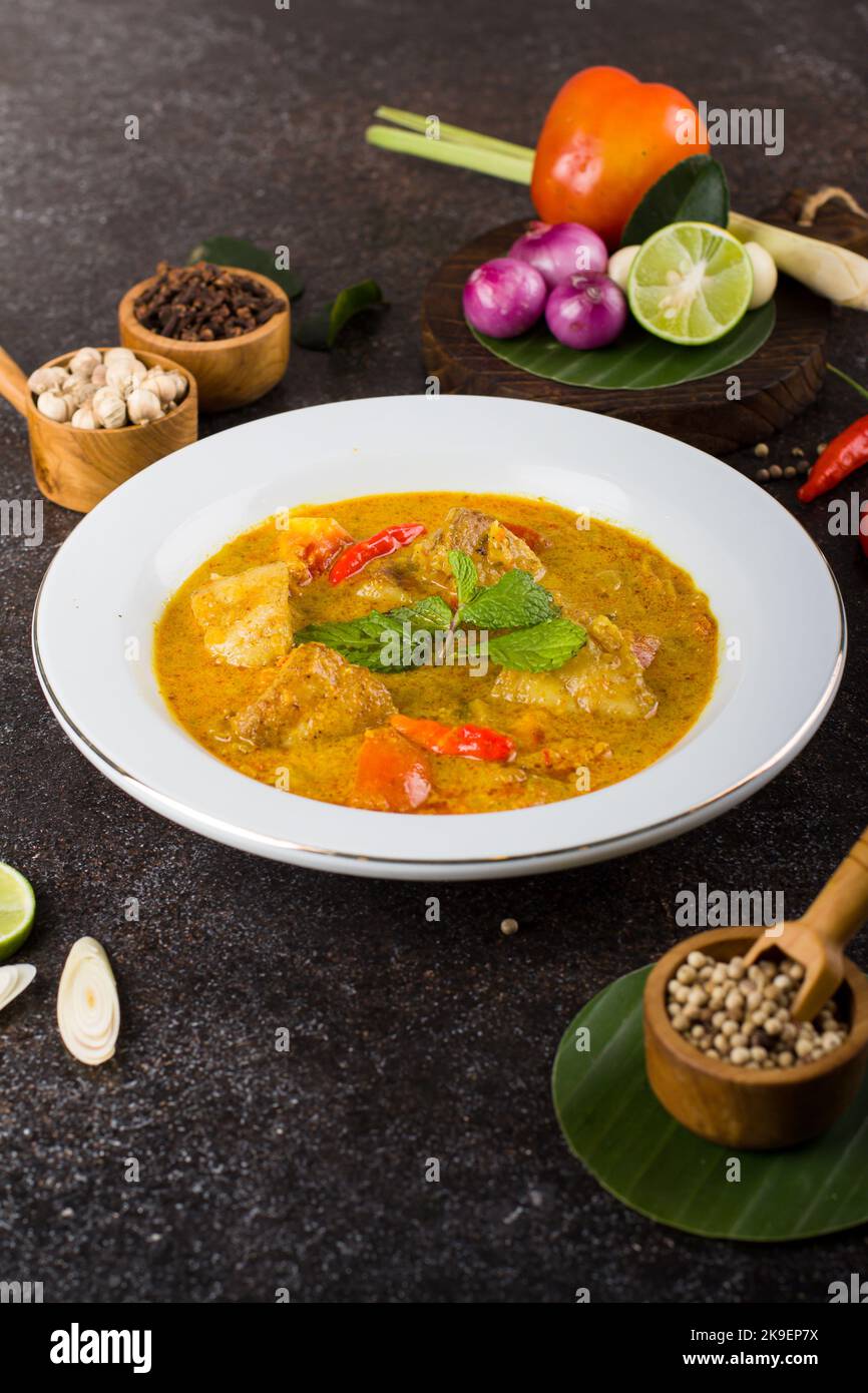 yellow curry fish or gulai ikan with tilapia fish seasoned with fresh