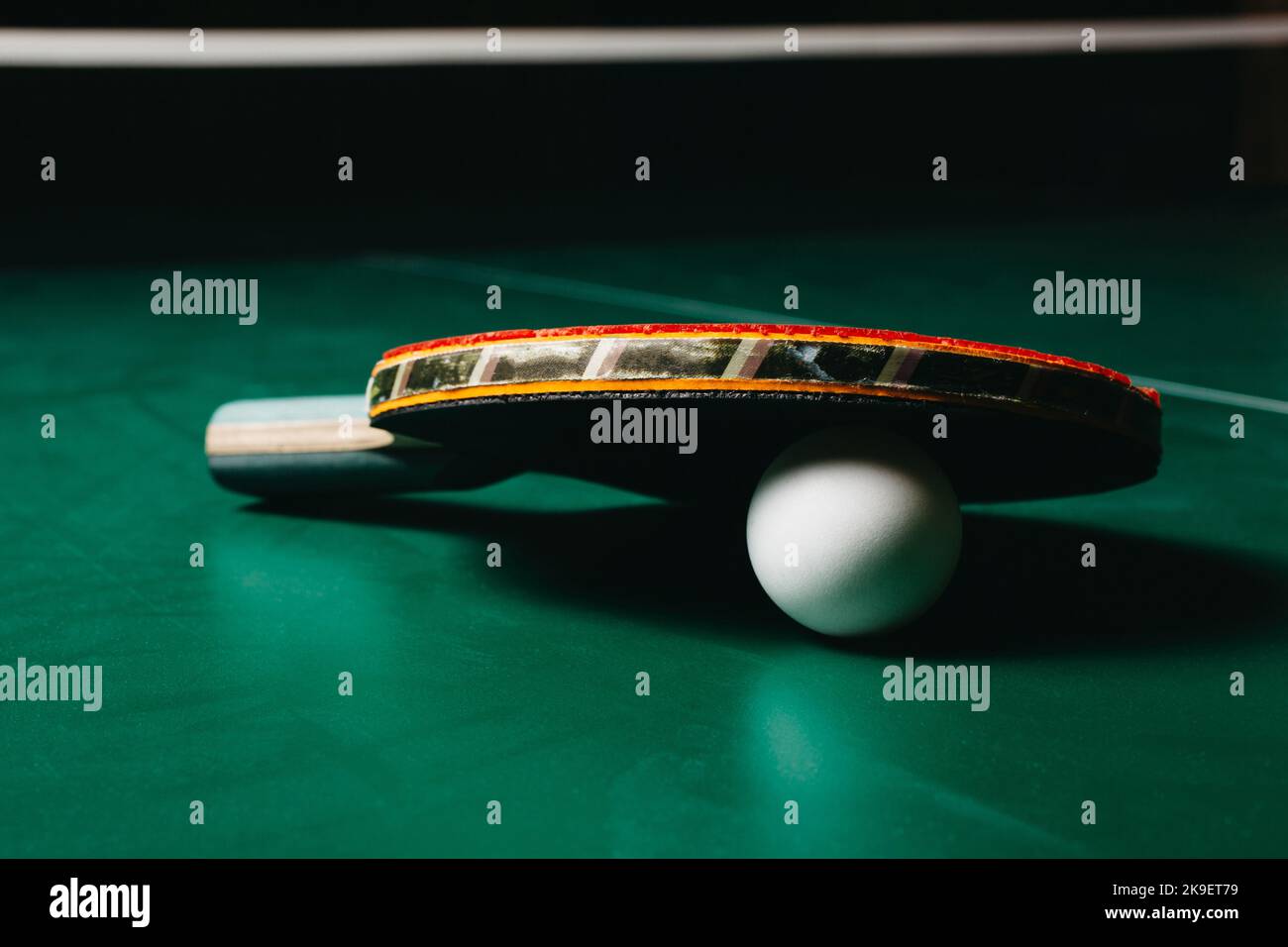 Ping pong racket leaning on ping pong ball Stock Photo - Alamy