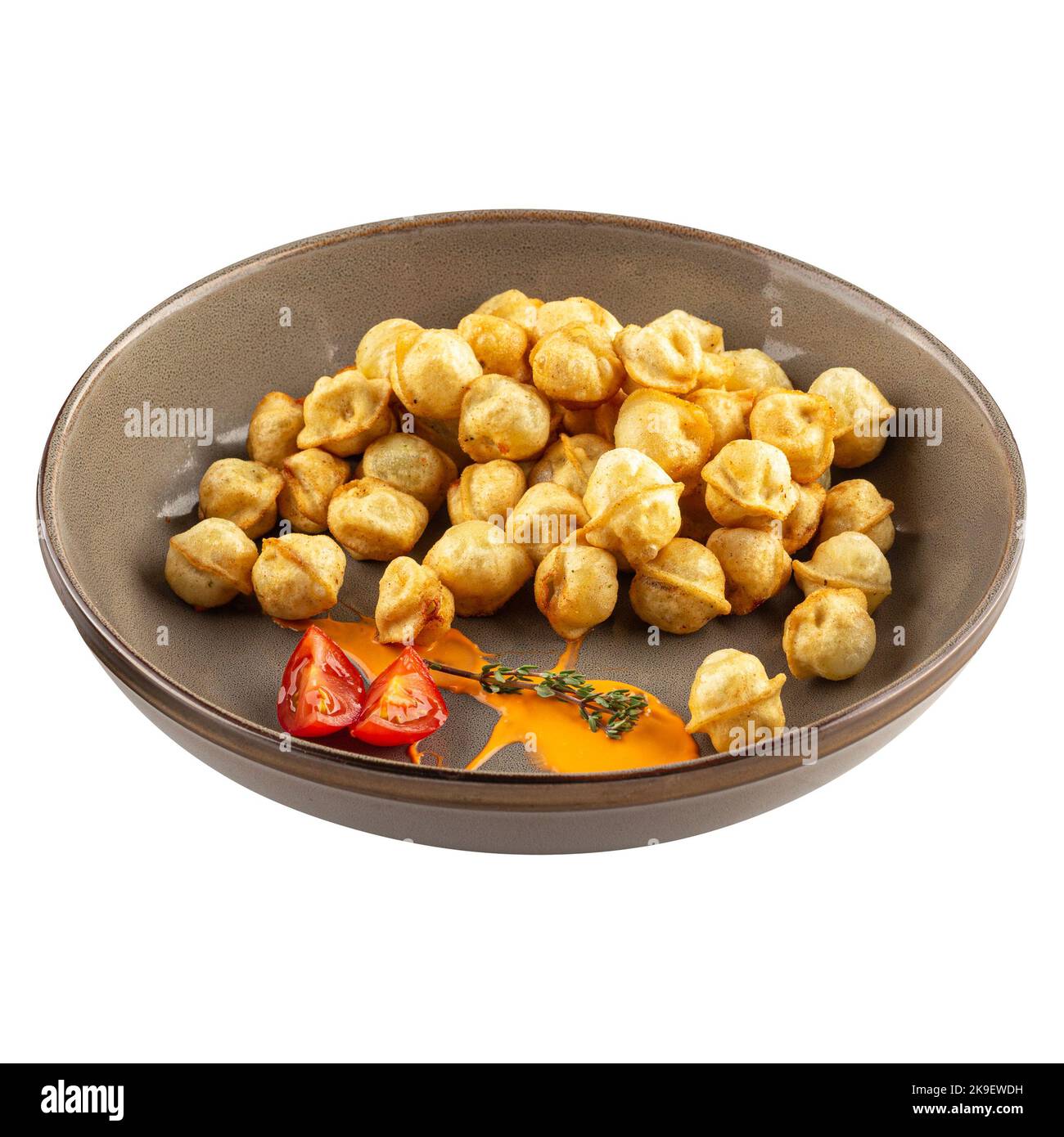 Portion of fried pelmeni dumplings with sauce Stock Photo