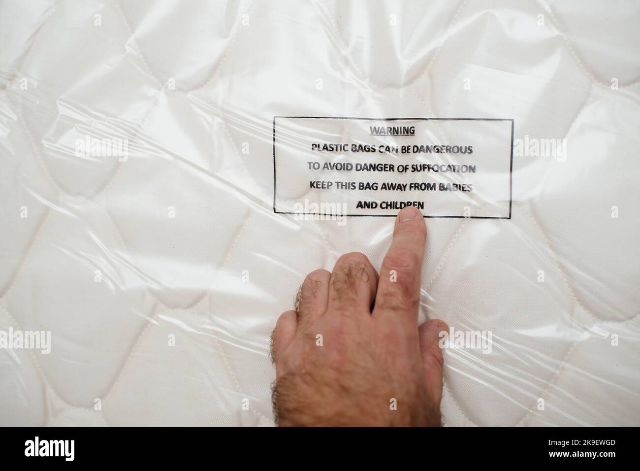 POV male hand pointing Mattress unboxing hand pointing to Warning