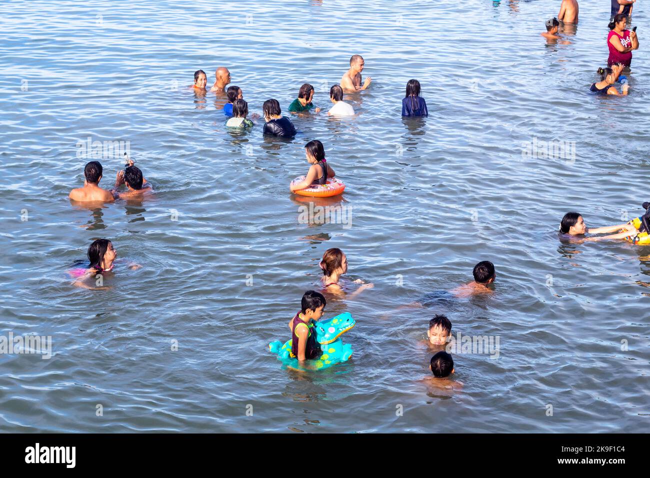 Cebuanos taking to the beach on a Sunday morning in Cebu, Philippines Stock Photo