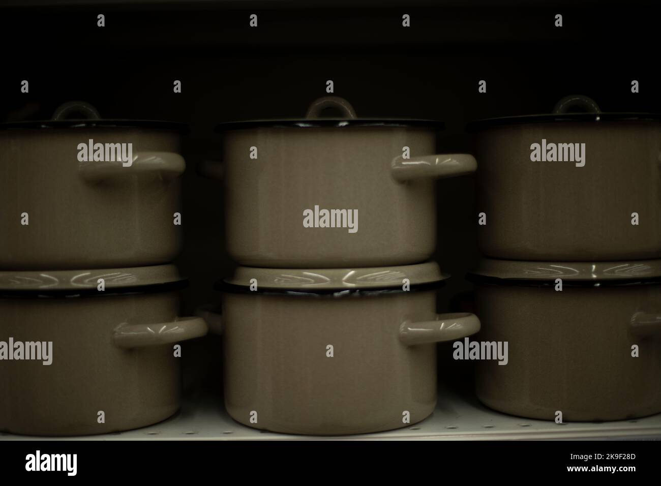 Lots of pots. Kitchen utensils on shelf. Sale of utensils. Steel pans