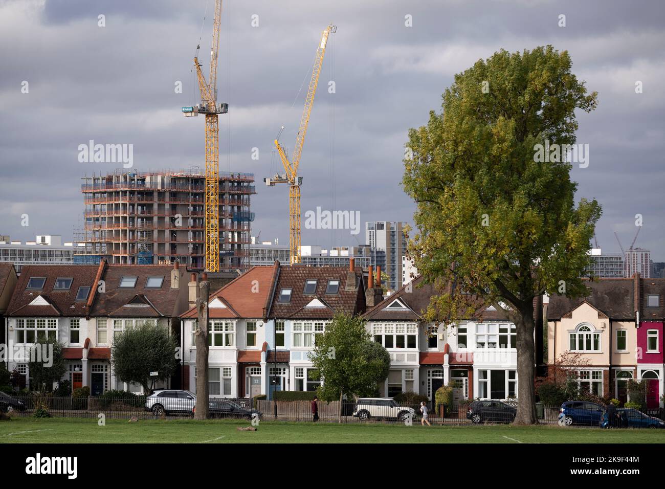 Residential London homes in the foreground and new high-rises under construction at Loughborough Junction, seen from Ruskin Park, a south London green space in Lambeth, on 6th October 2022, in London, England. Stock Photo