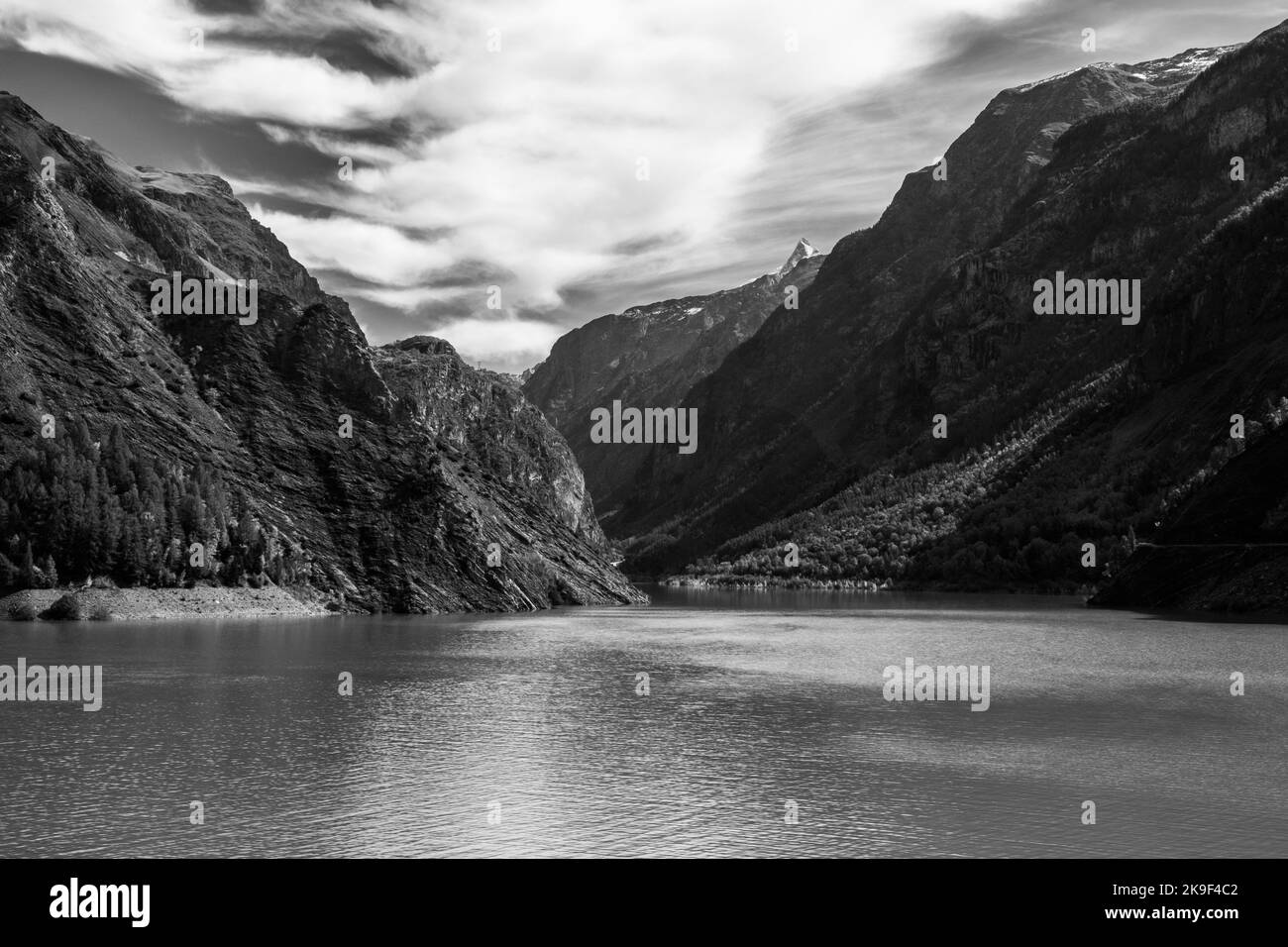 Lake and Mountain in the Alps in the past. Reminiscing the younger days hiking in the Alps in black and white Stock Photo