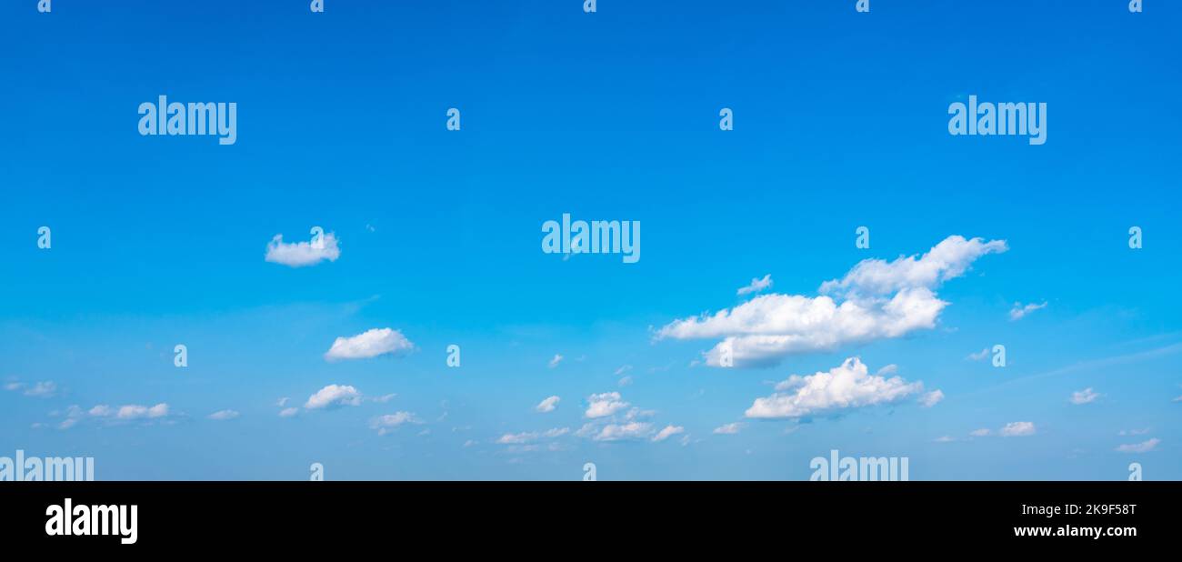 Blue panoramic sky background with small white clouds Stock Photo
