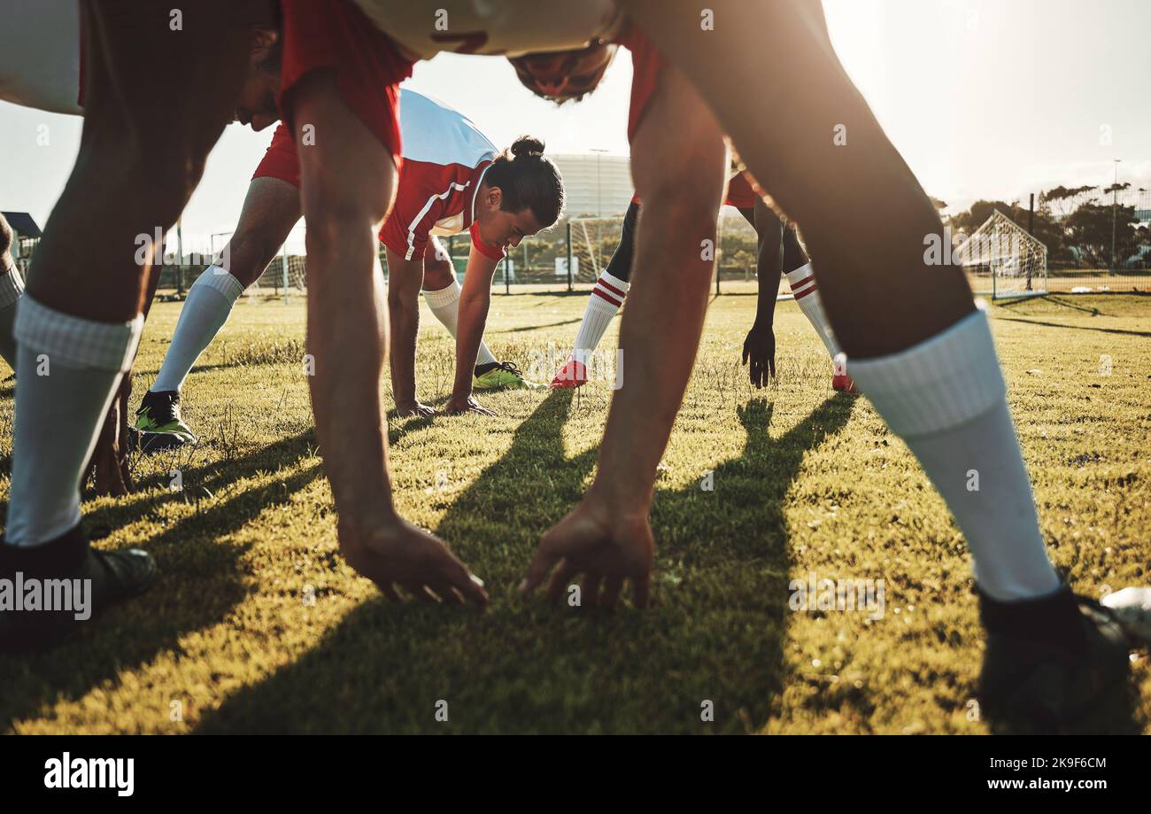 Soccer field, sports men and stretching body on sports stadium grass to start training, fitness and exercise workout. Football player team group warm Stock Photo