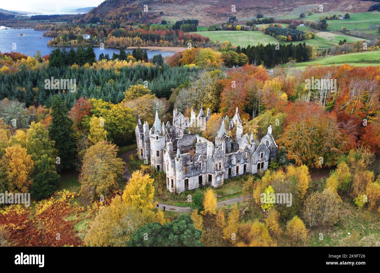 The ruins of Dunalastair House, near Pitlochry, Perthshire, are surrounded by trees displaying their autumn colours. Picture date: Friday October 28, 2022. Stock Photo