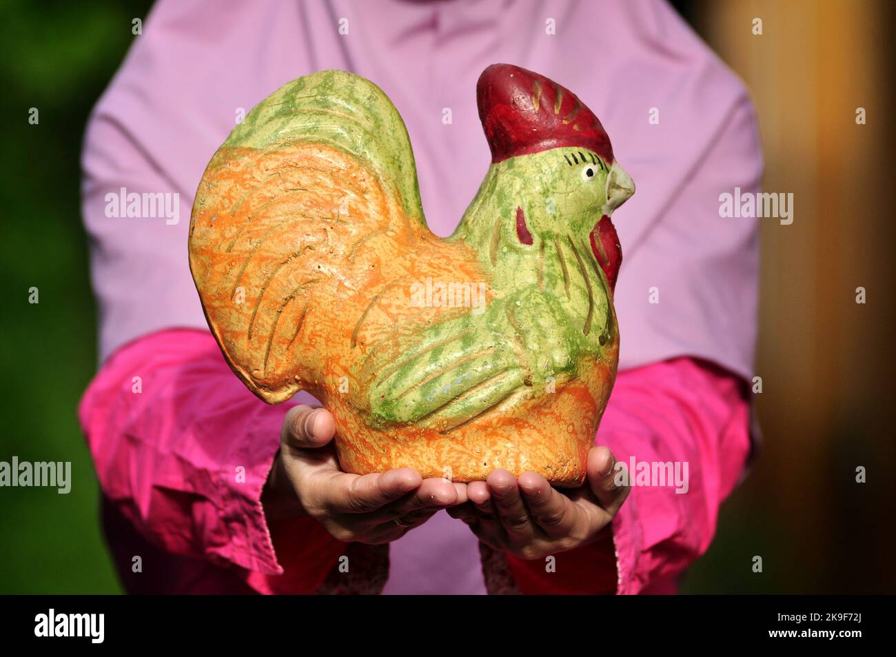 Holding chicken piggy bank made of clay selective focus Stock Photo - Alamy