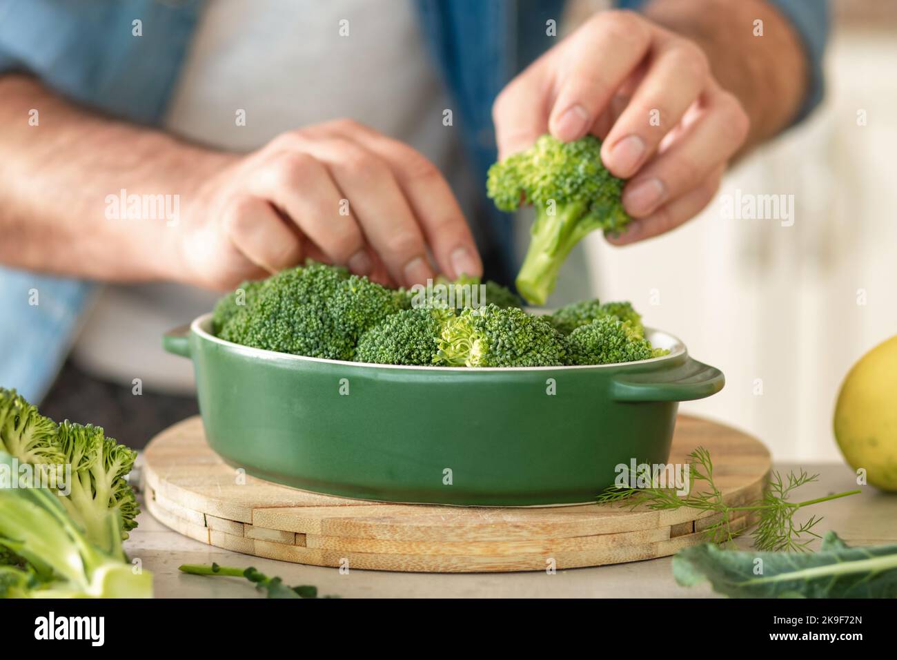 Male hands cooking diet healthy food of baked broccoli Stock Photo